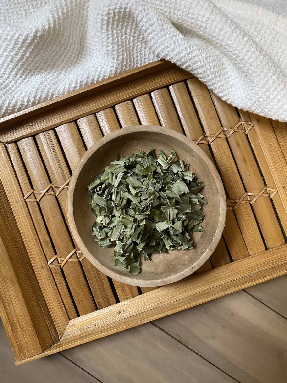 Pandan leaves in a bowl on a tray.