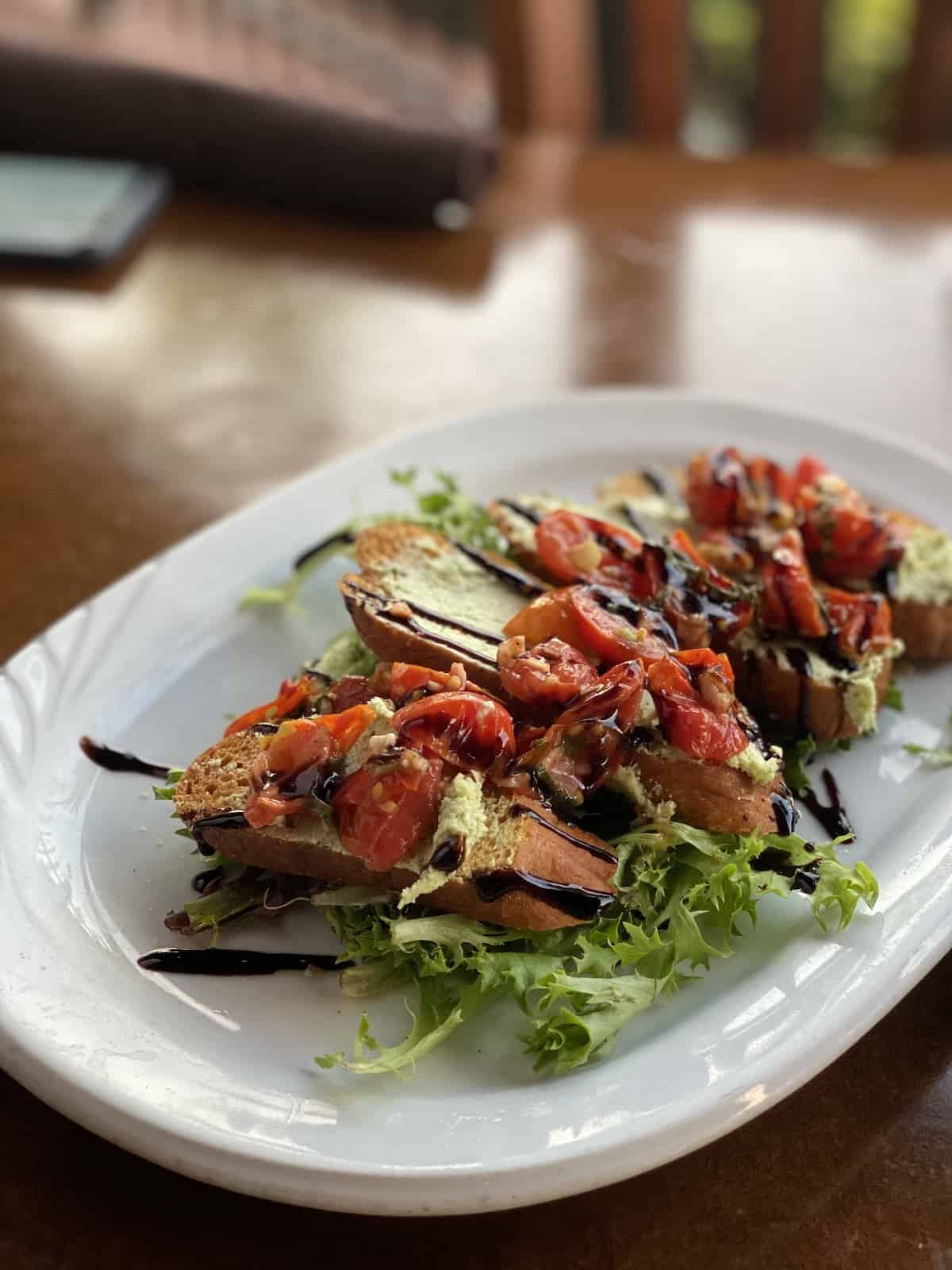 Bruschetta on lettuce on white plate at Mattison's Bradenton restaurants