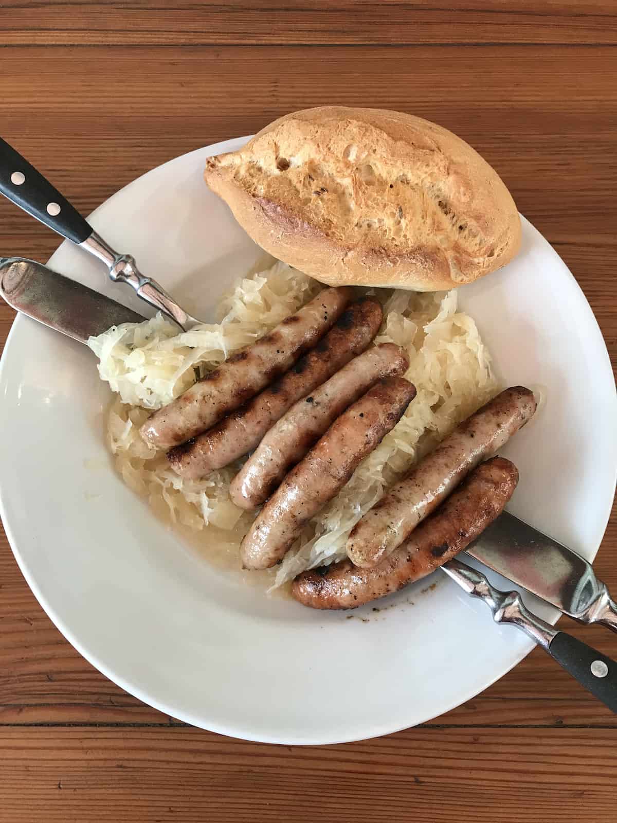 Sausages on sauerkraut with a roll at the Historic Sausage Kitchen in Regensburg Germany.