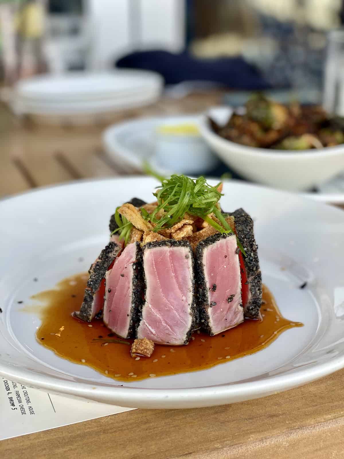 Ahi tuna appetizer with crispy onions and seaweed salad.