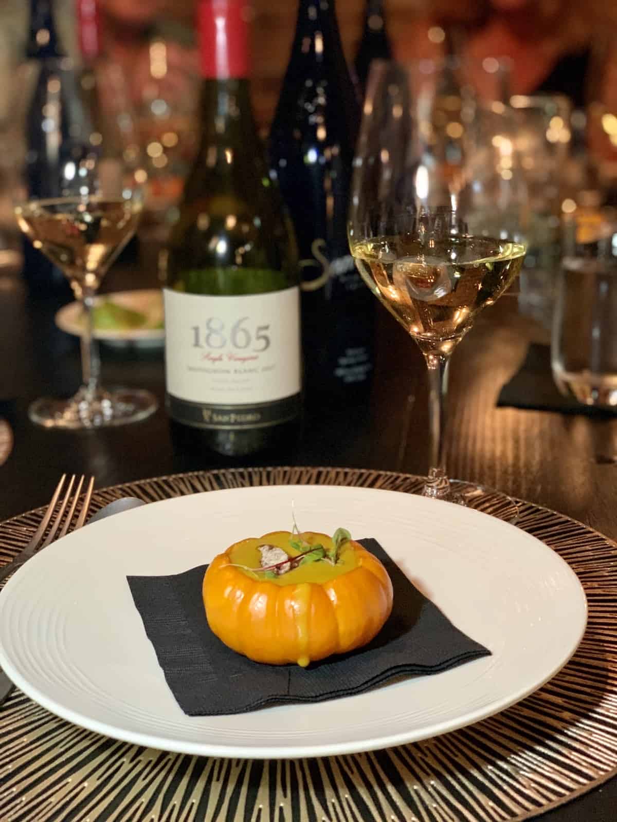 Pumpkin soup served in a small pumpkin.