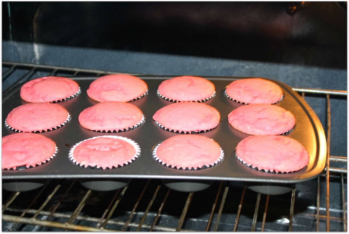 Pink cupcakes baked in oven.