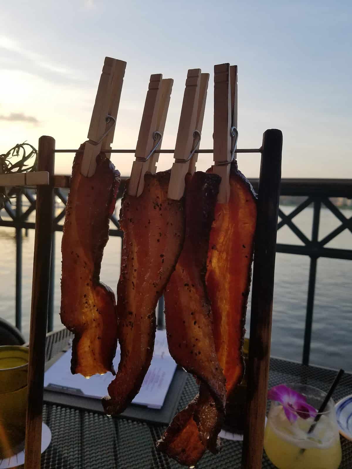 Candied Bacon on a clothesline at Edison in Disney Springs