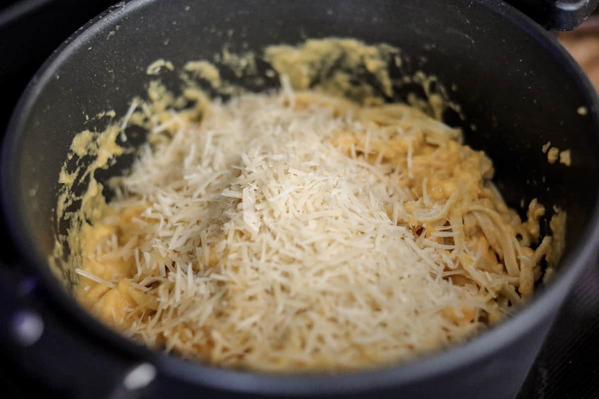 Adding cheese to Butternut Squash pasta.