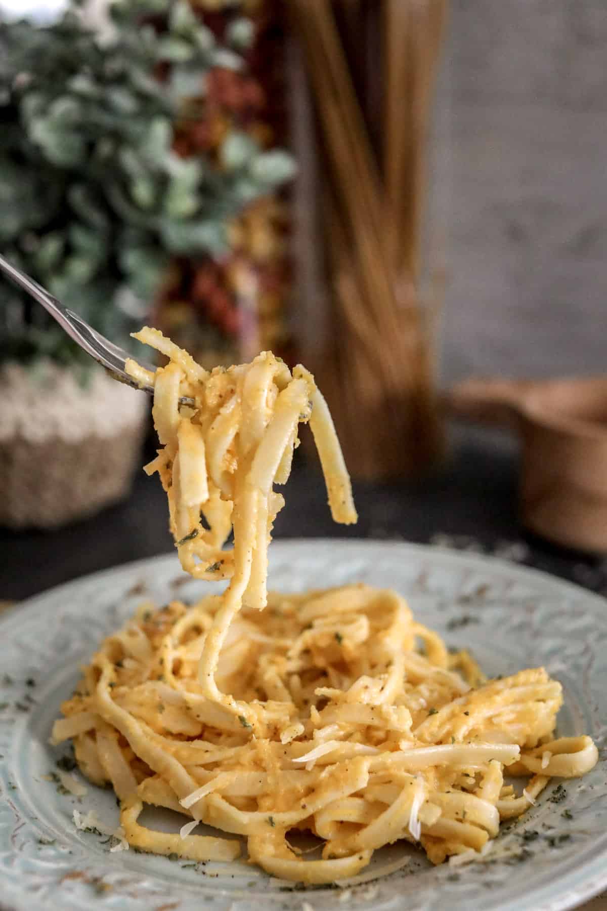 Butternut Squash Pasta Sauce with Fettuccine on fork over plate.