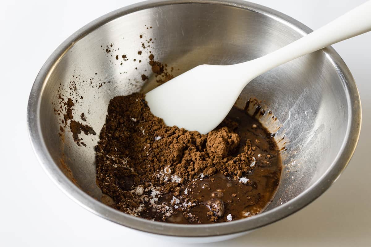 Powdered sugar, cocoa powder, sea salt, cinnamon, coconut oil, water, and vanilla extract in a large bowl.