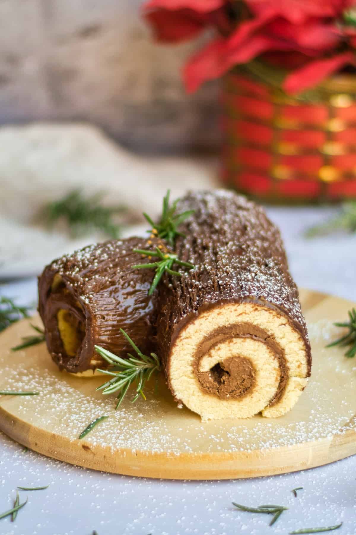 Vanilla rolled cake with chocolate frosting and Christmas decoration.