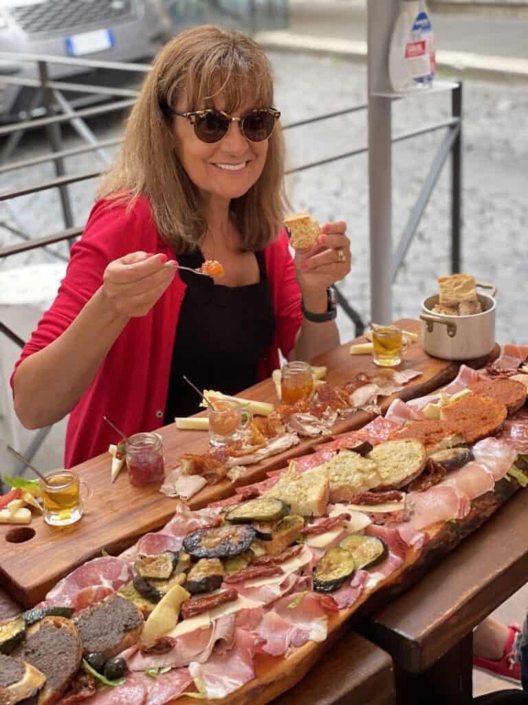 Kelly in Rome eating charcuterie.