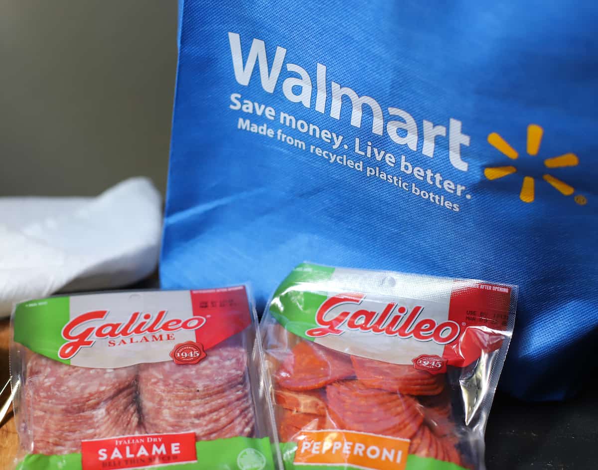 Walmart bag, a package of salame, and a package of pepperoni.