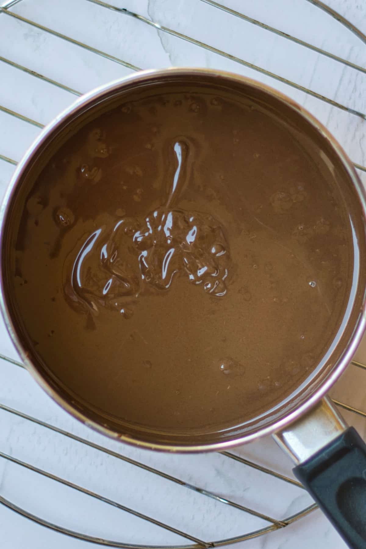 Heavy cream and chocolate in pan.