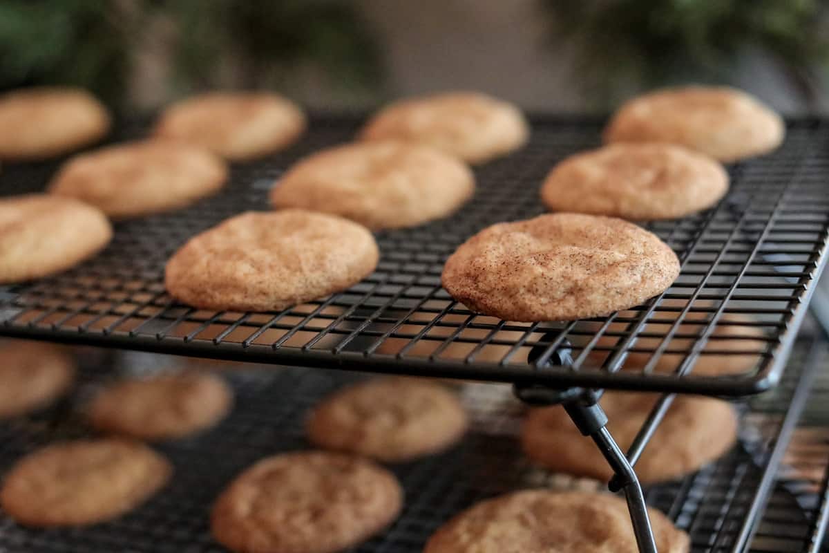 Snickerdoodle cookies on a wire rack.