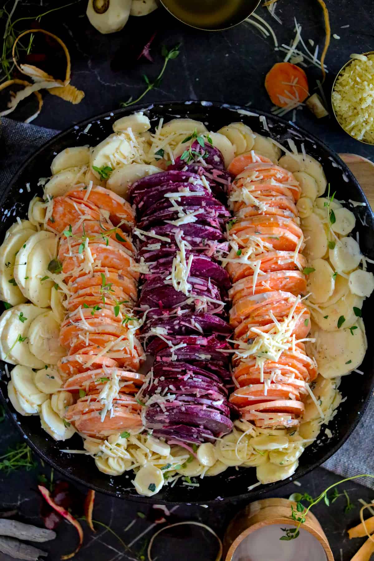 Vegetables in dish by color with sauce and cheese on top.