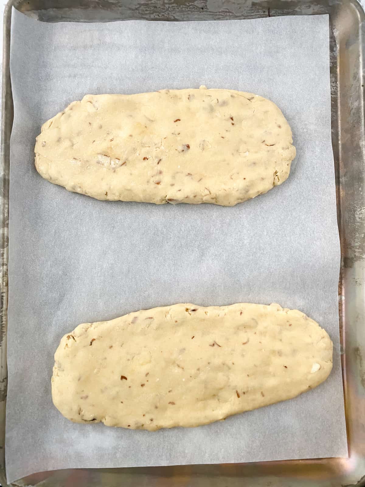 Biscotti dough on parchment lined cookie sheet.