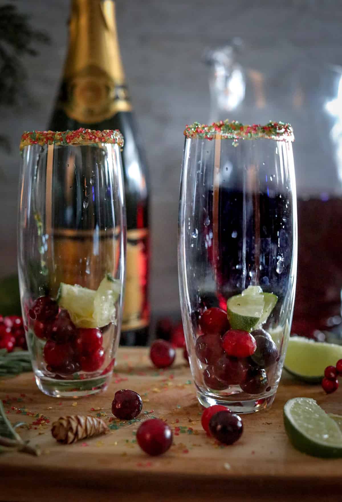 Flute glasses with cranberries and lime.