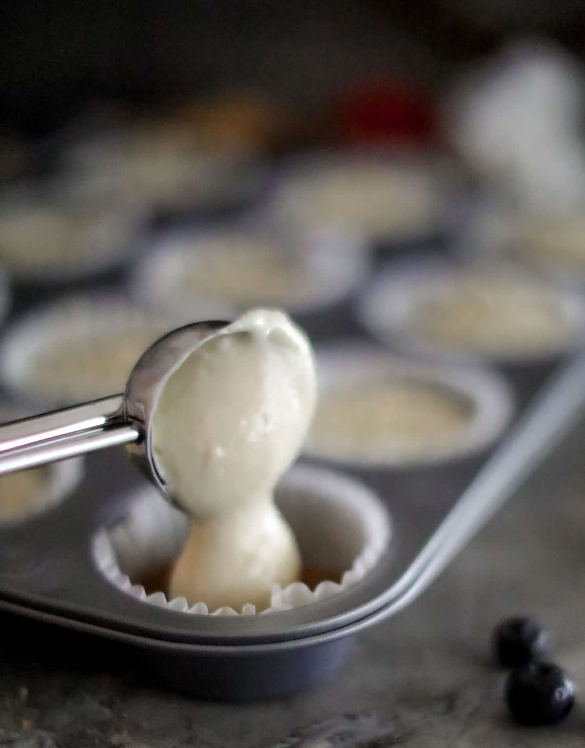 Batter going into muffin cup.