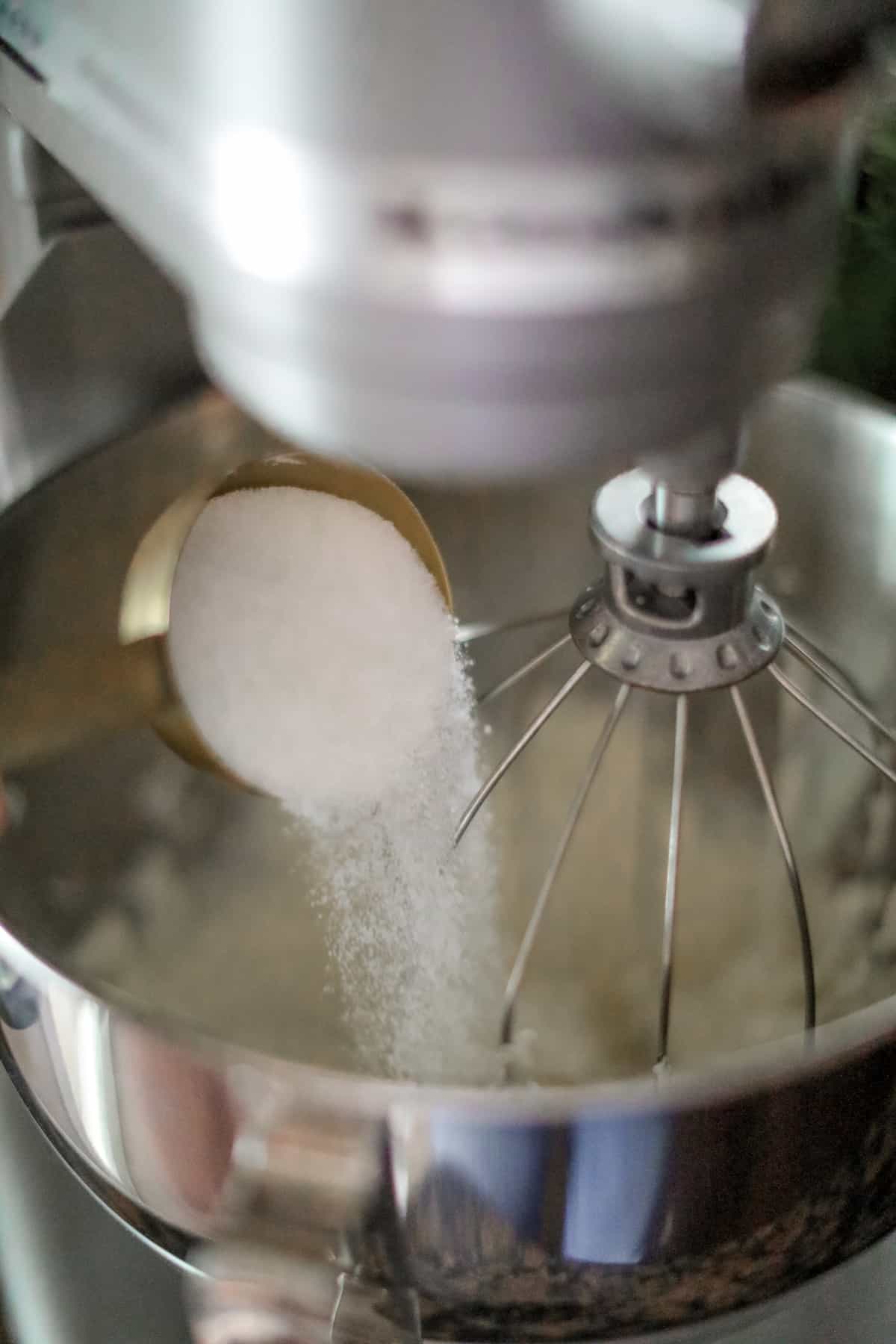 Sugar going into large bowl of stand mixer.
