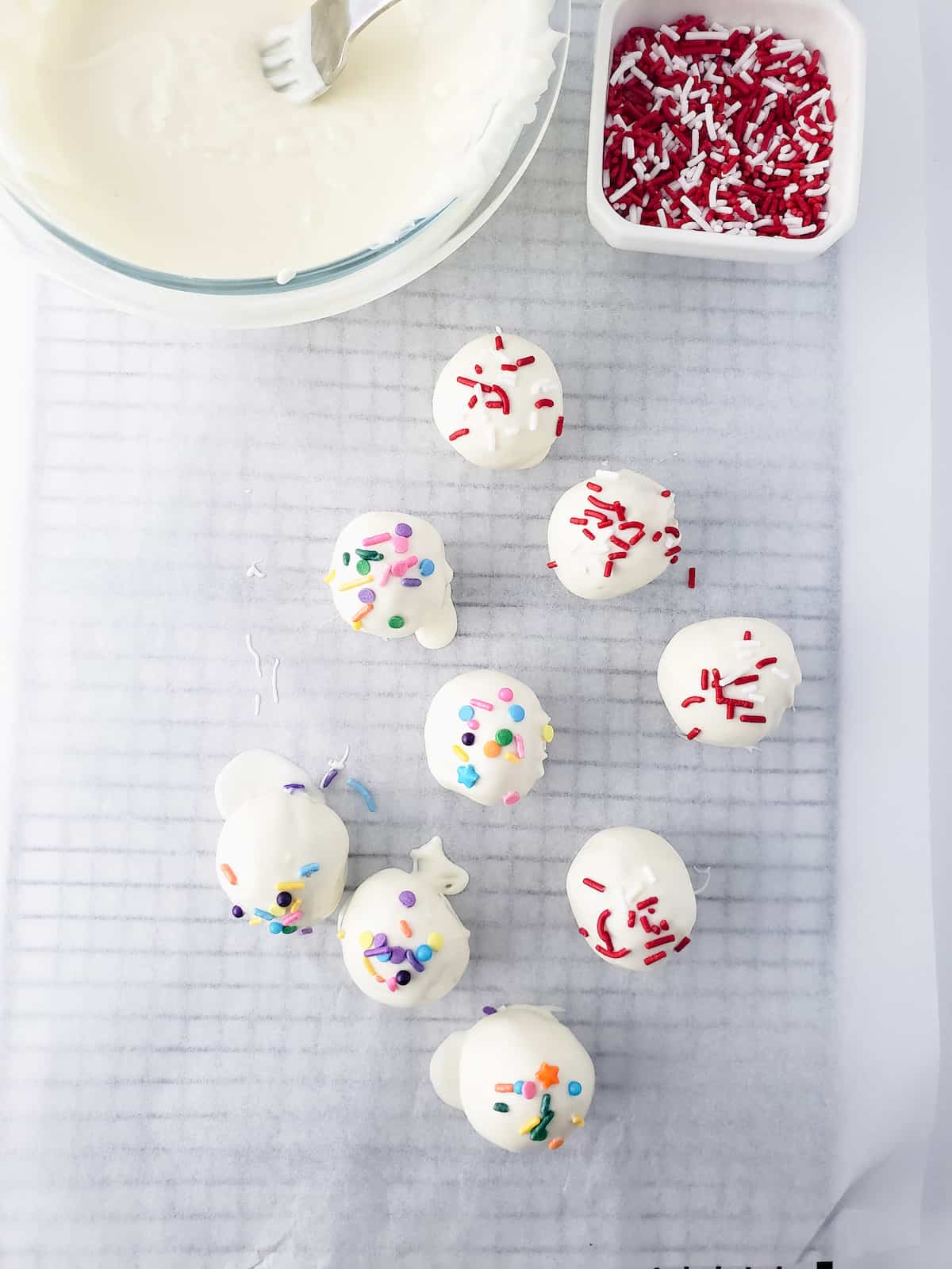 Chocolate dipped cookie dough bites with sprinkles.