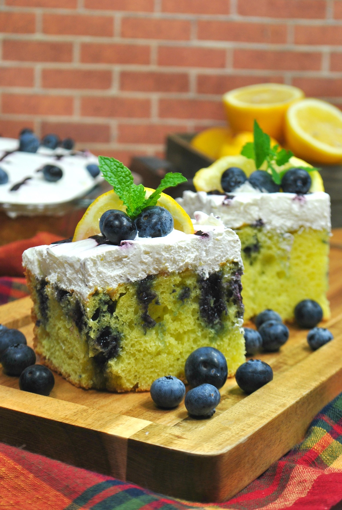 Lemon cake with blueberries and whipped topping.
