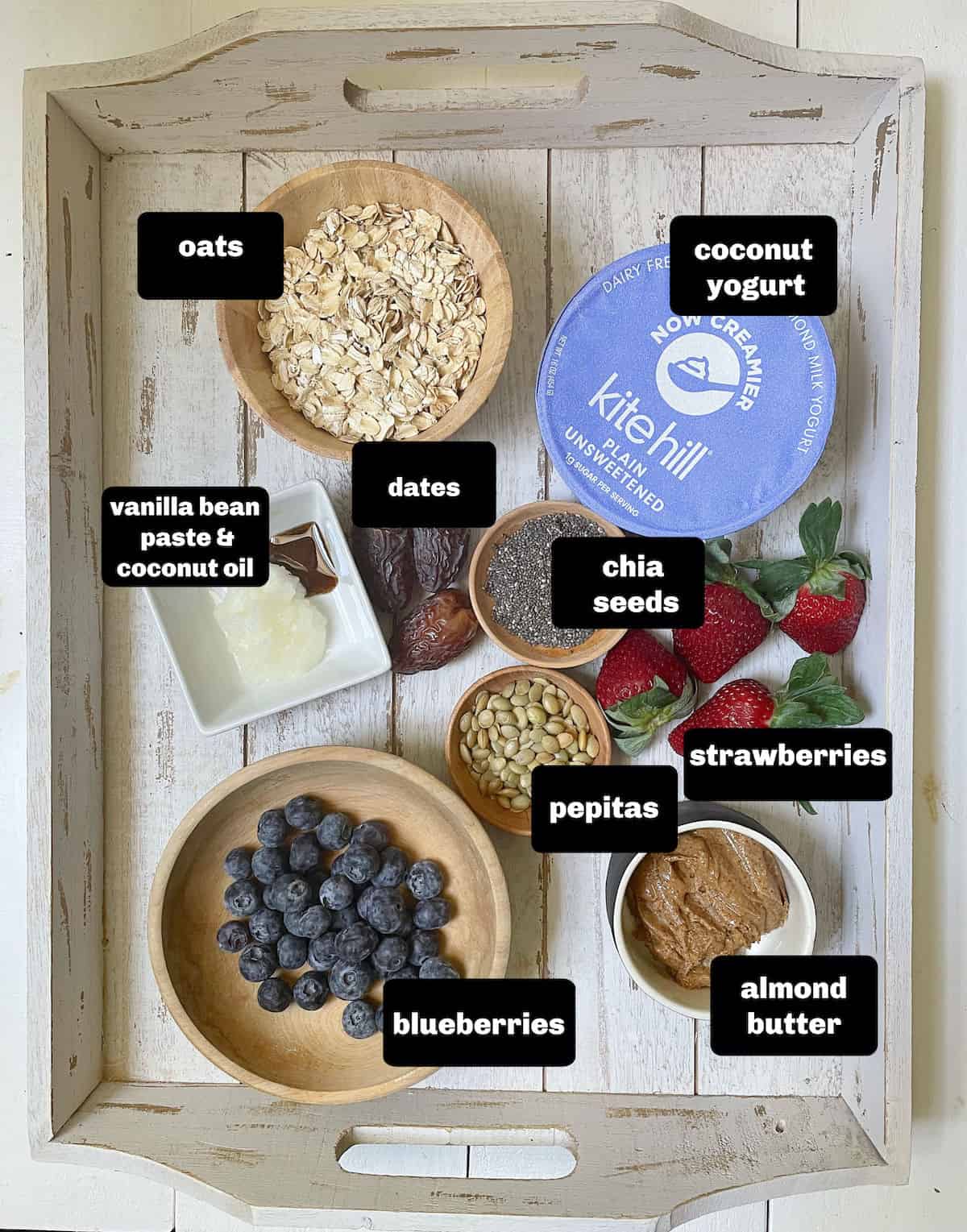 Labeled ingredients for oatmeal cups with yogurt and fruit.