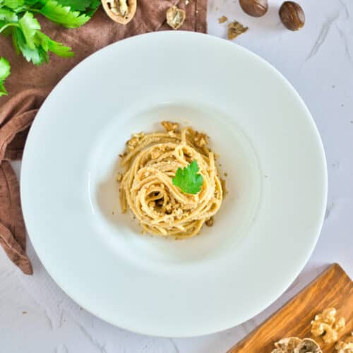 Walnut sauce with pasta in a white dish.