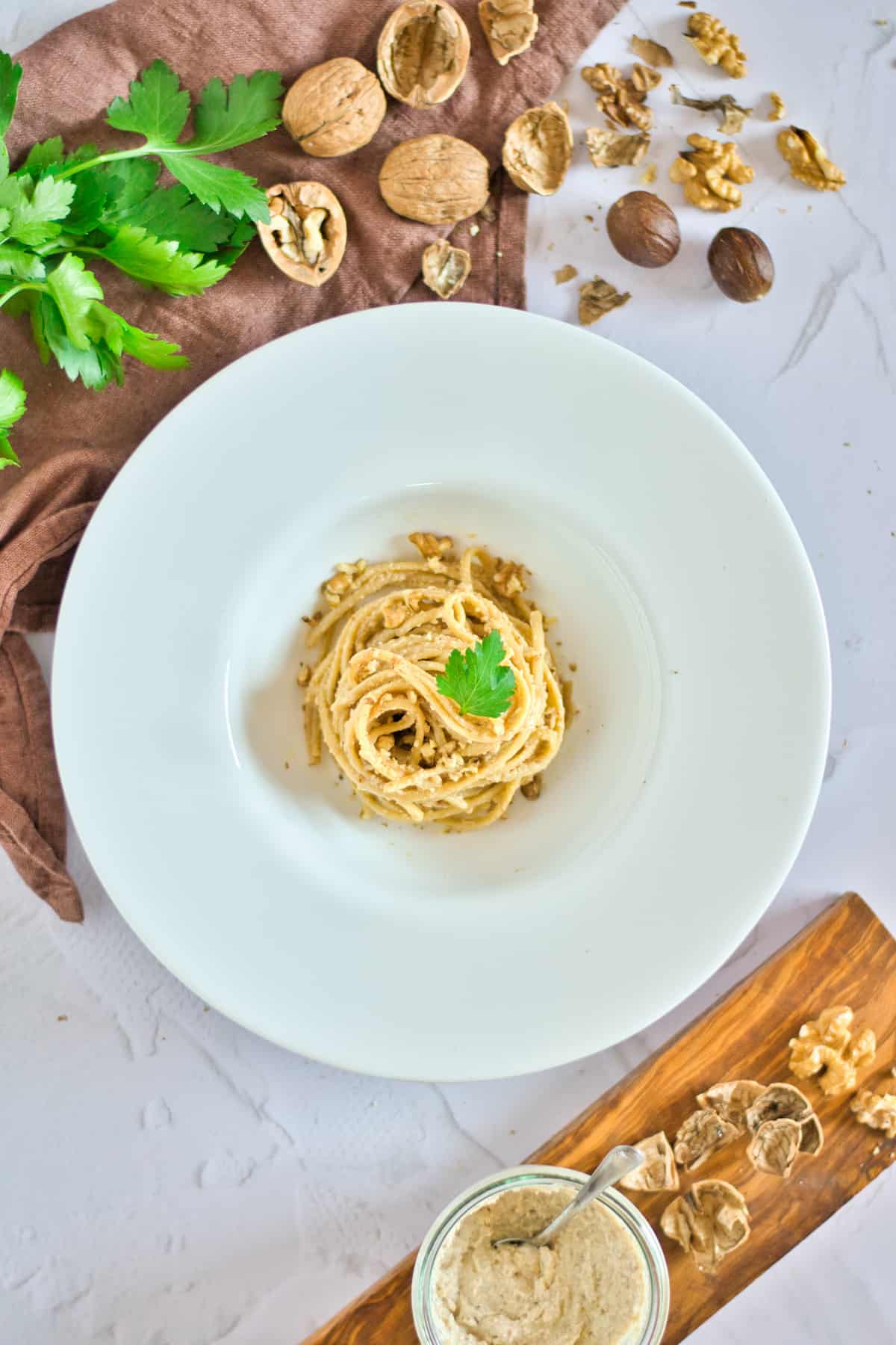 Walnut sauce with pasta in a white dish.
