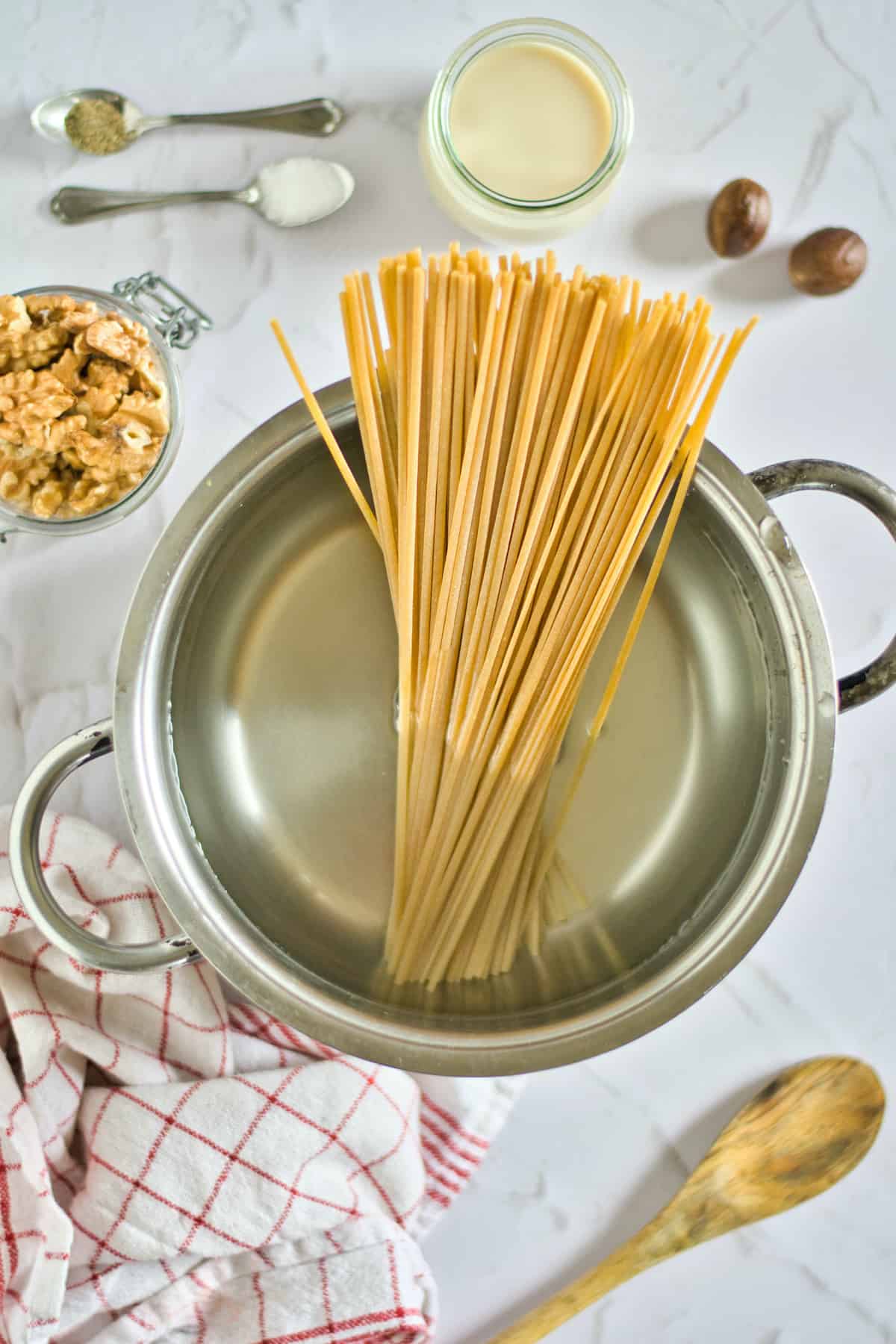 Spaghetti in a pan of water.