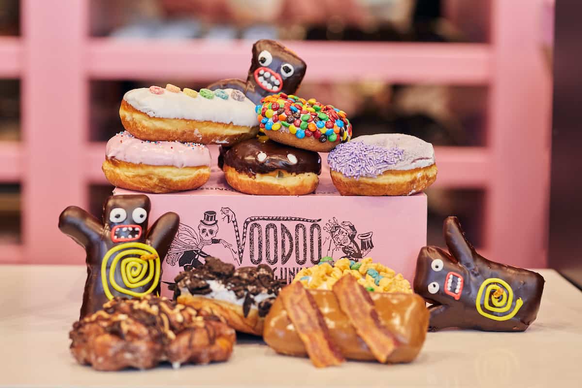 A variety of doughnuts on a pink box.