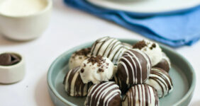 OREO cookie balls truffles on a teal plate on a white table graphic for Pinterest.