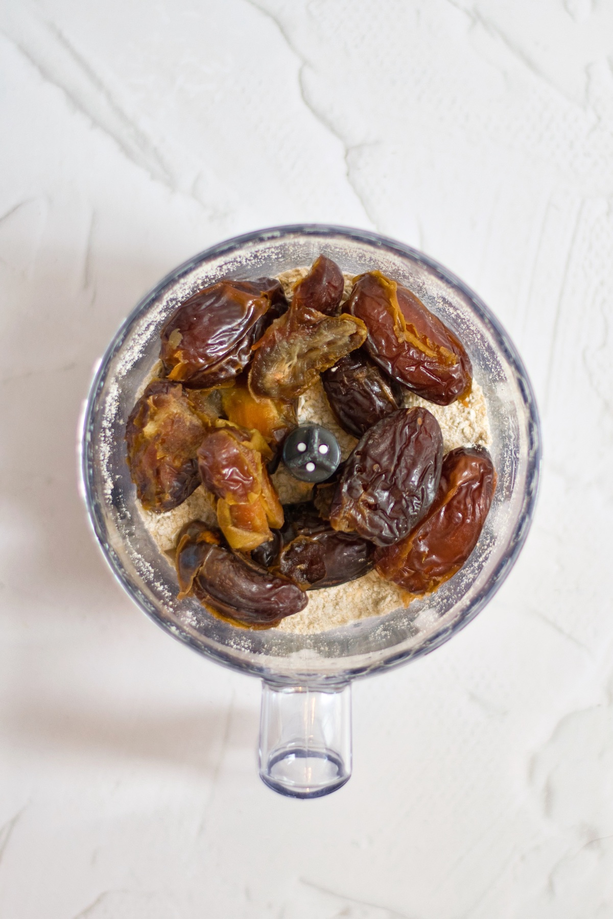 Dates and oats in a food processor.