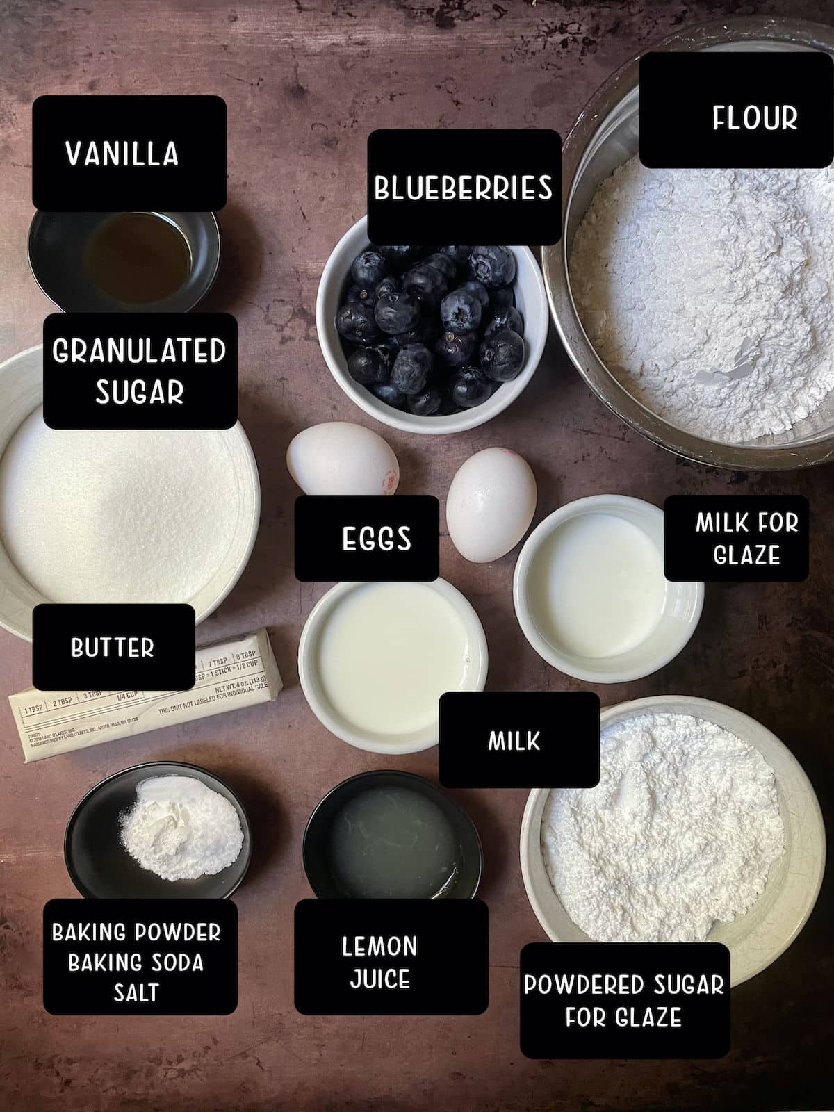 Ingredients for blueberry donuts on a table.