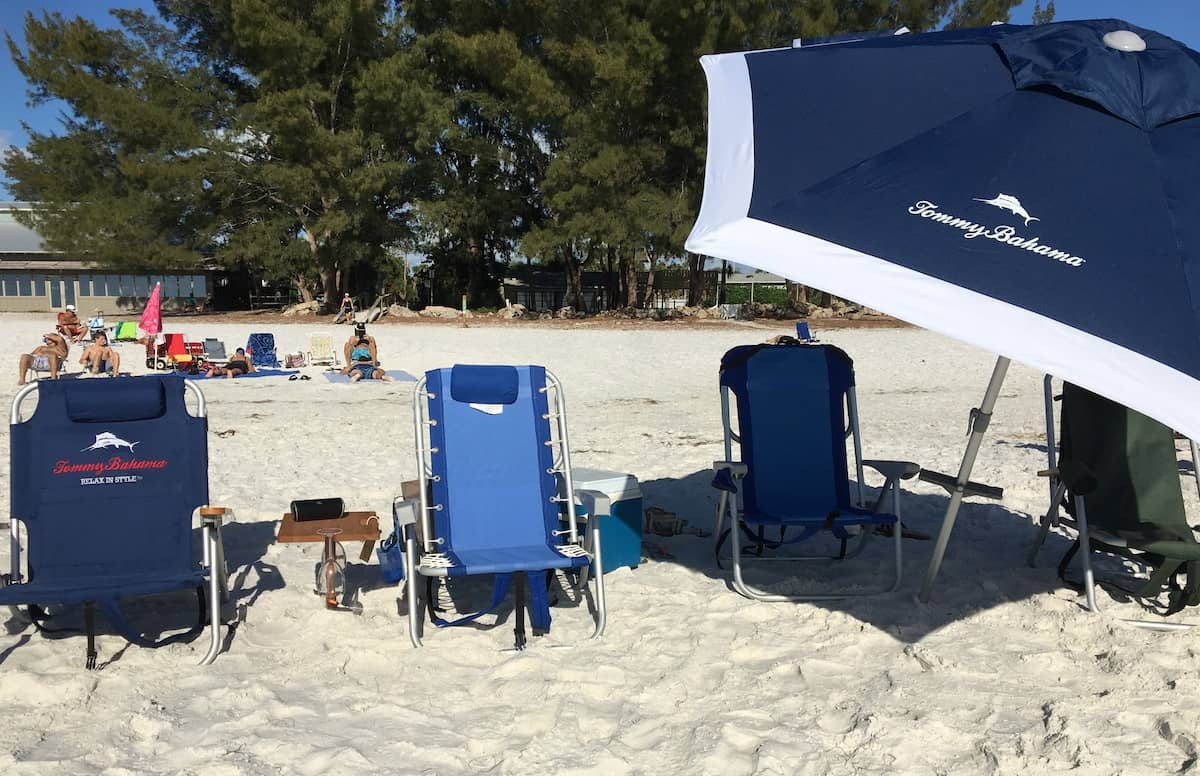 Beach chairs and umbrella set up for family of 4.