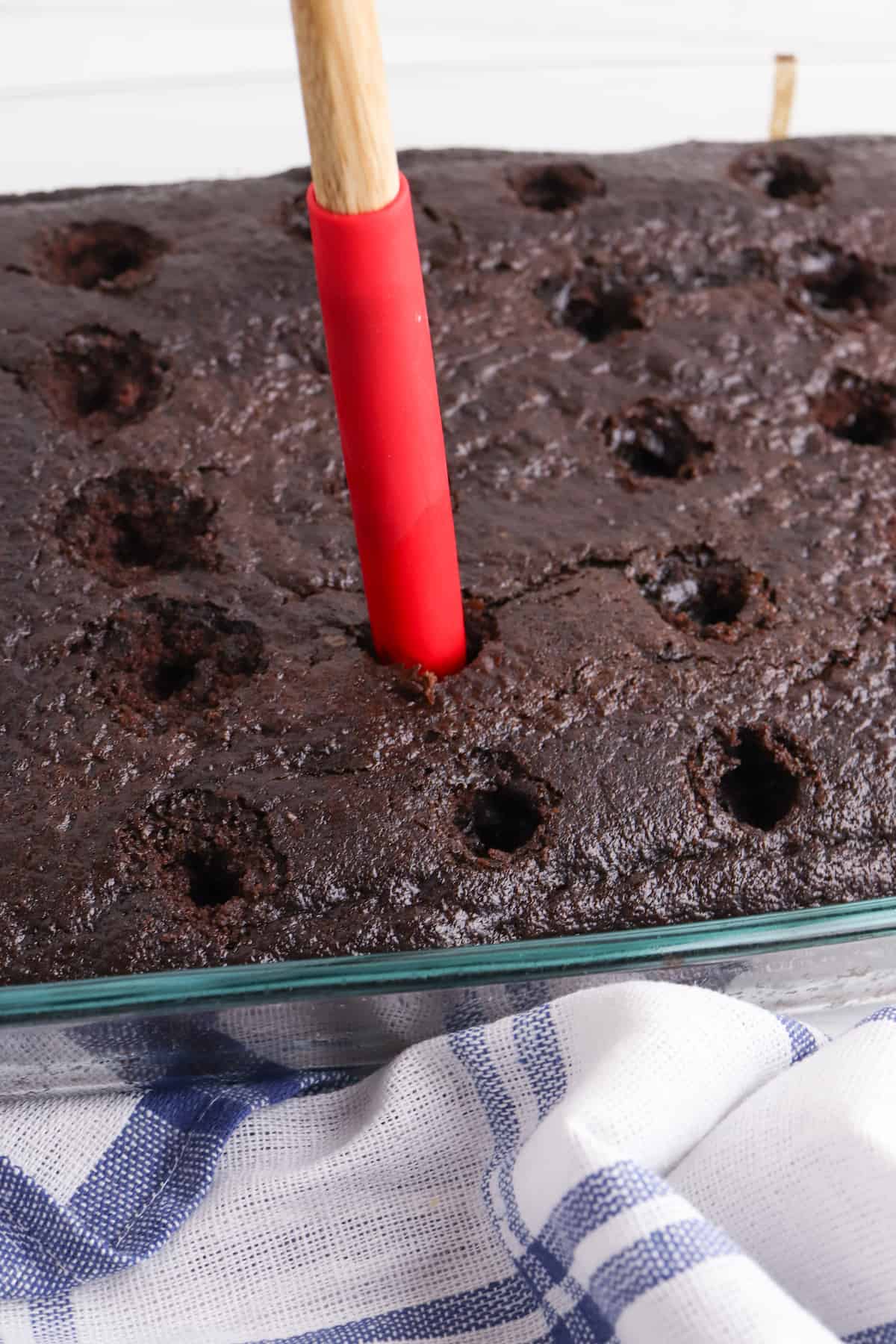 Chocolate cake with holes for drizzling caramel.