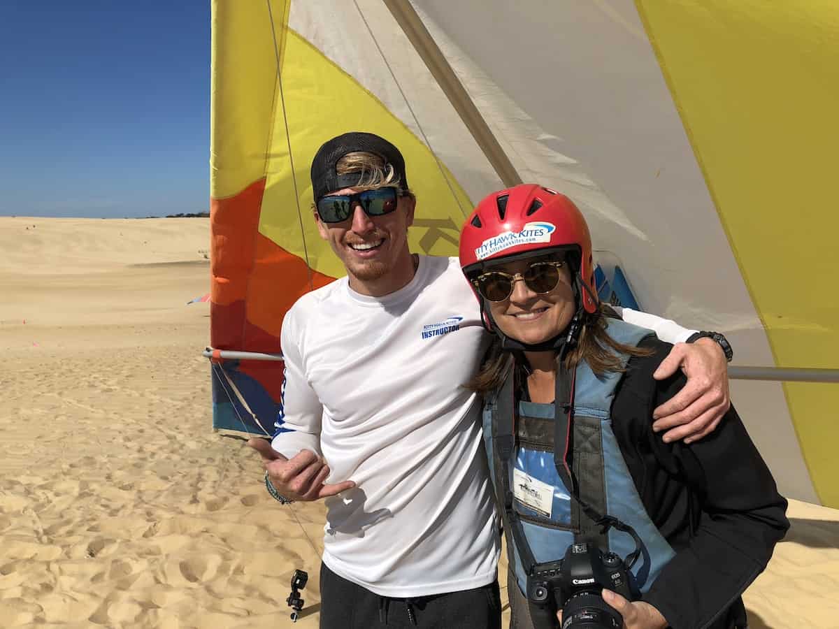 Woman and man with hang gliding kite.