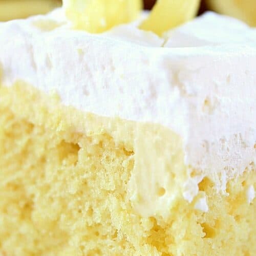Lemon poke cake on a white plate.