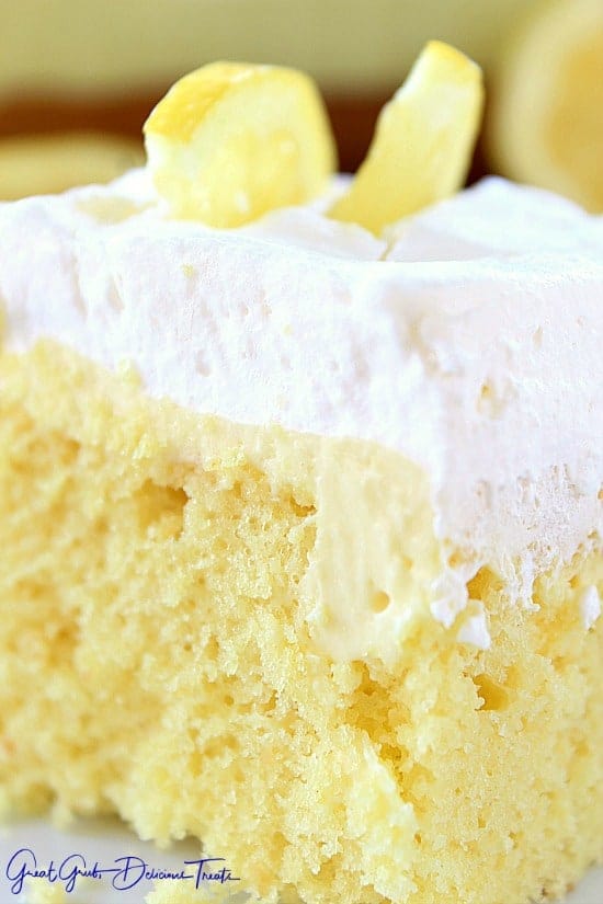 Lemon poke cake on a white plate.