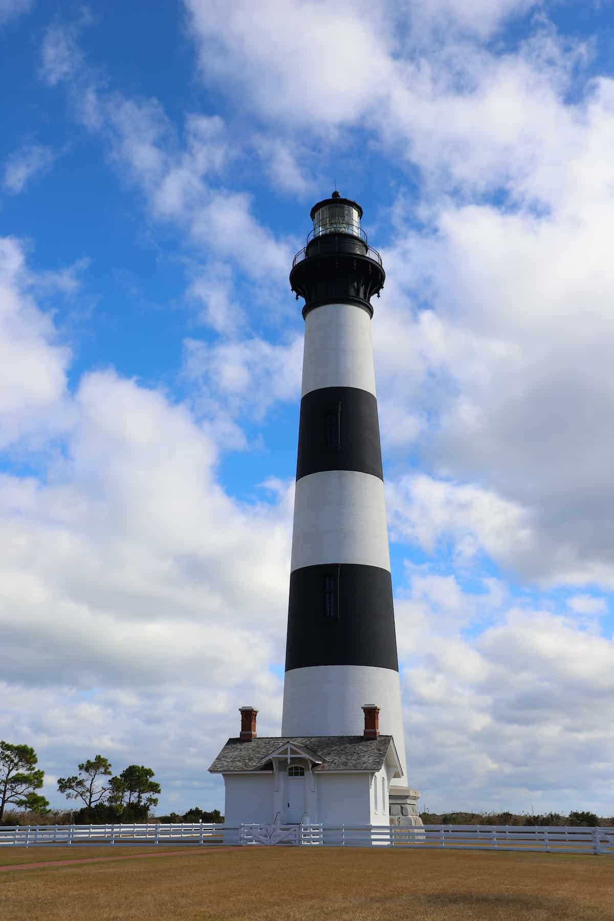 Bodie black and white striped Lighthouse with blue sky in background.