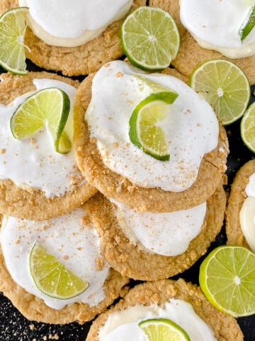 Key lime Crumbl cookies with lime slice on a black table.