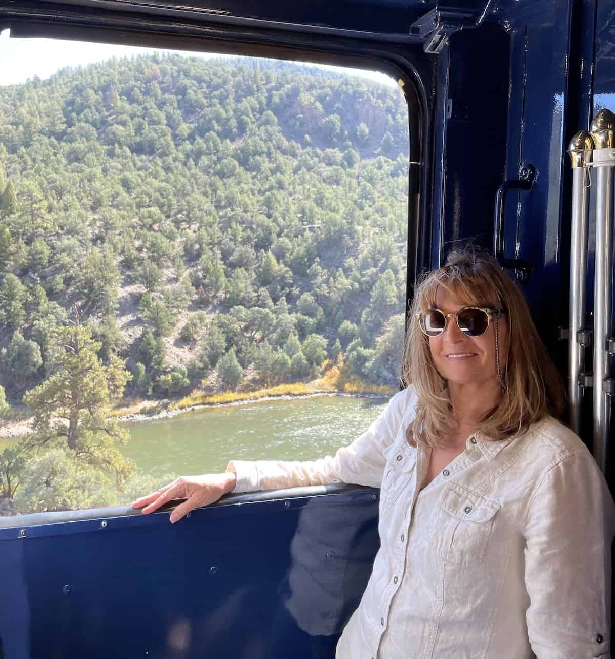 Woman in vestibule of a train.