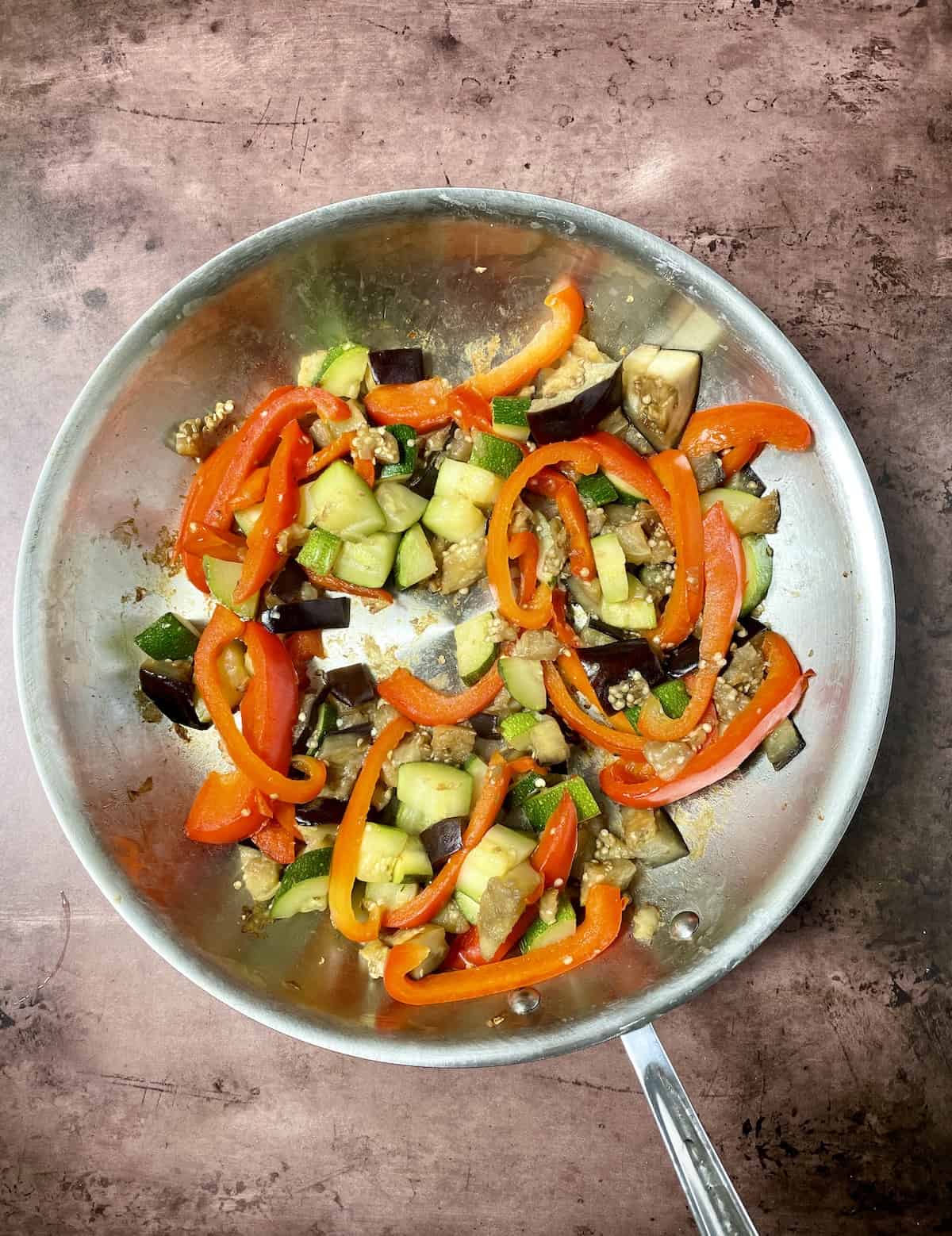 Cooked vegetables in pan.