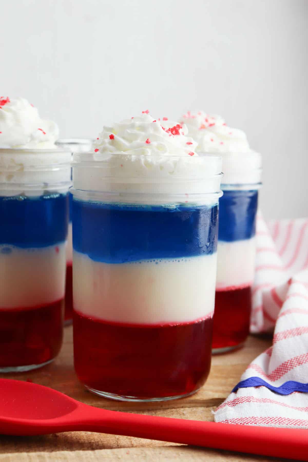 Red, white, and blue patriotic jello parfait in a mason jar.