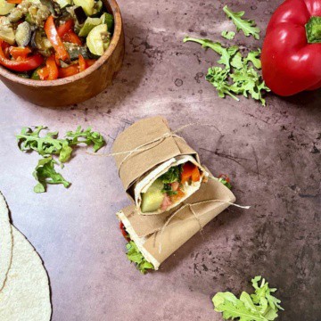 Vegetable wrap wrapped in butcher paper wrapped with twine.
