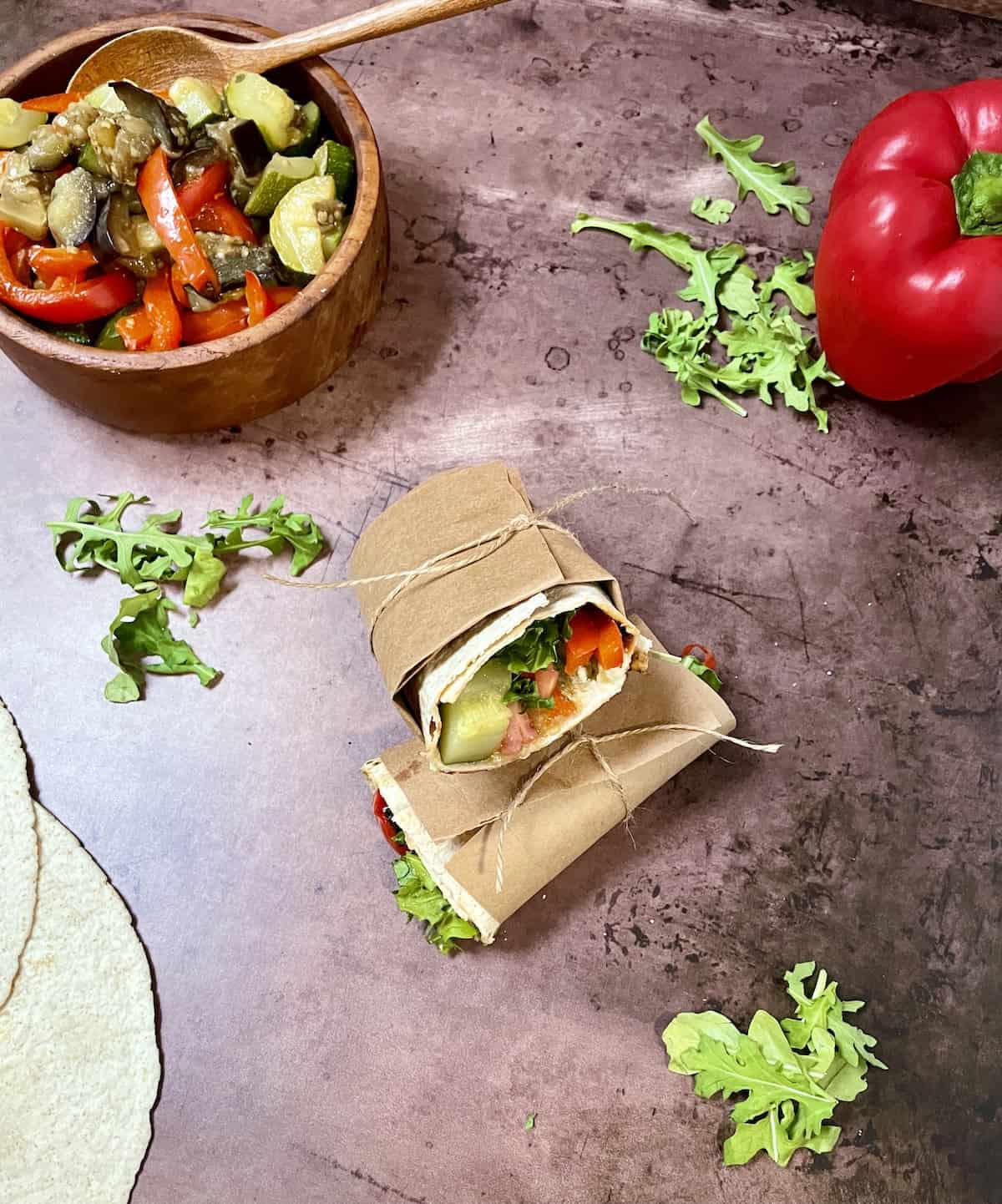 Vegetable wrap wrapped in butcher paper wrapped with twine.