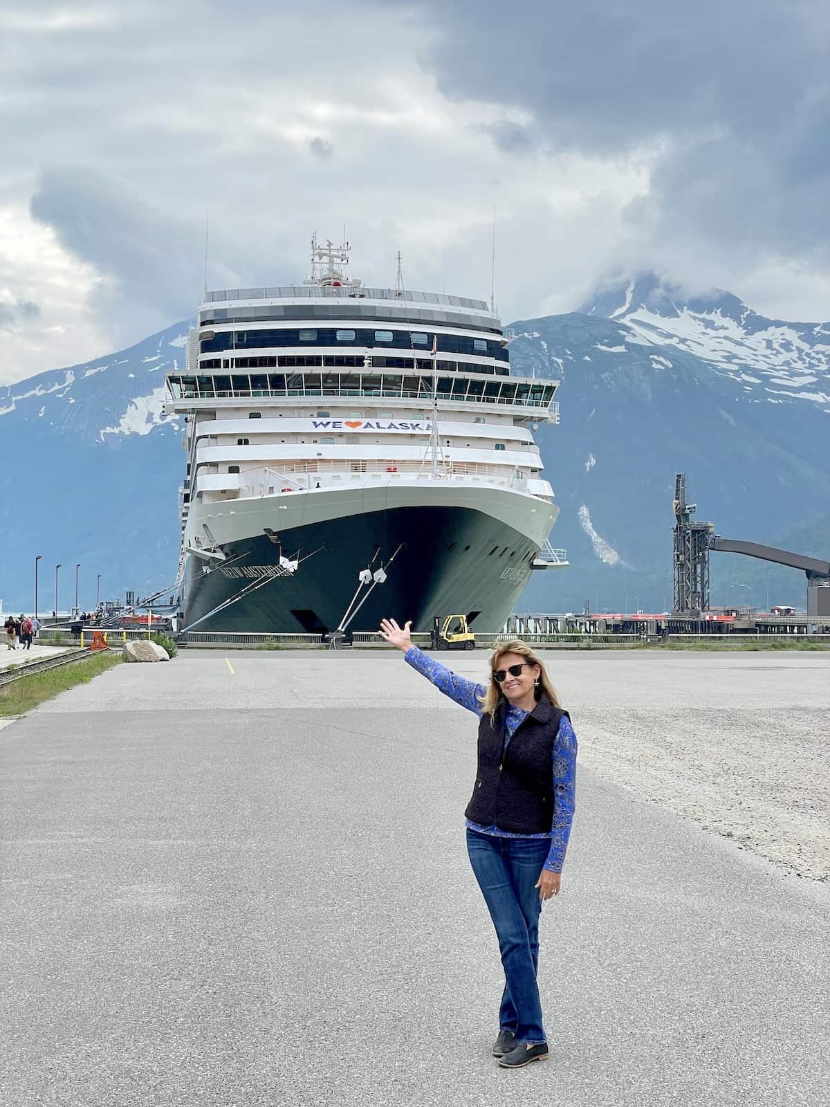 Woman in front of cruise ship.
