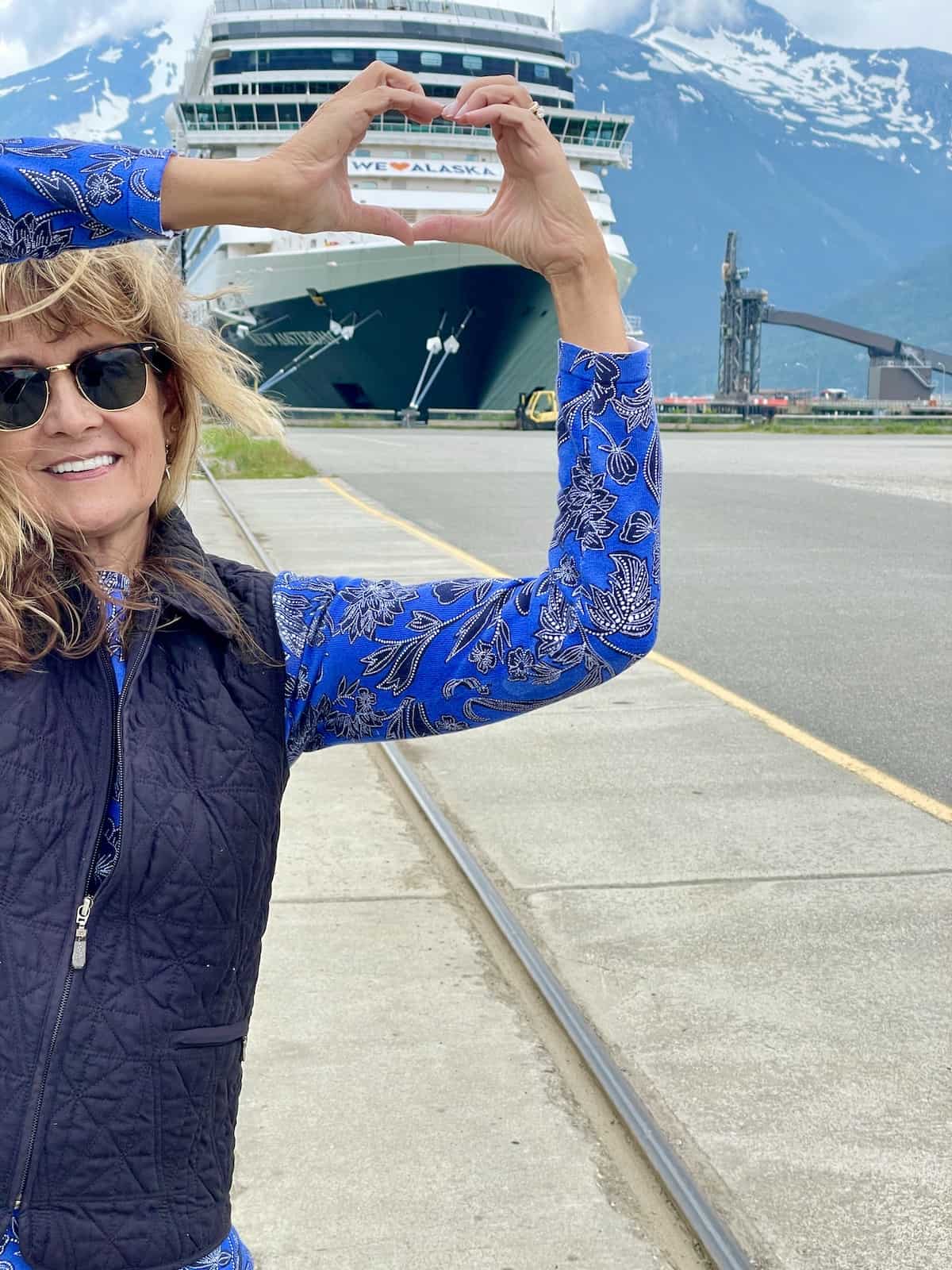 Woman in front of docked ship.