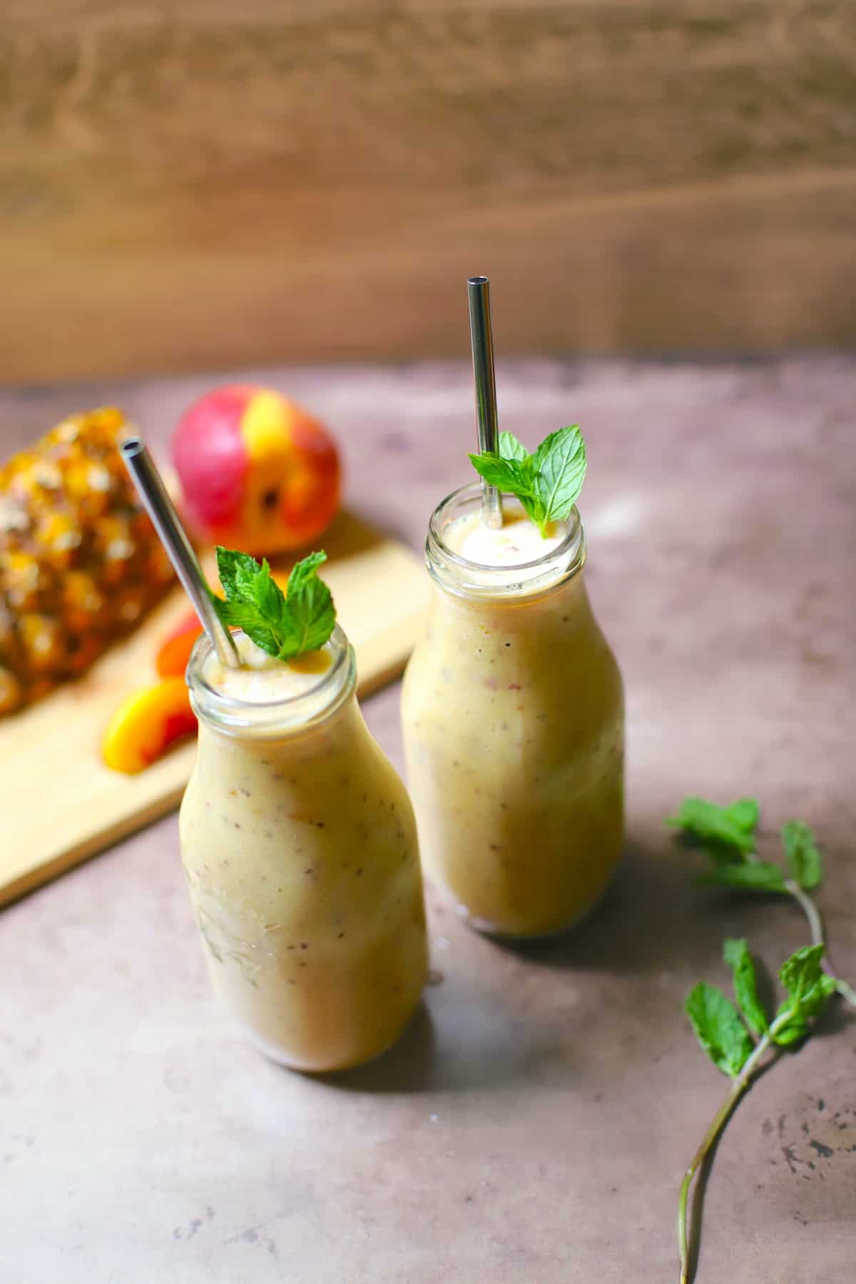 Peach smoothie with peach slice and mint.