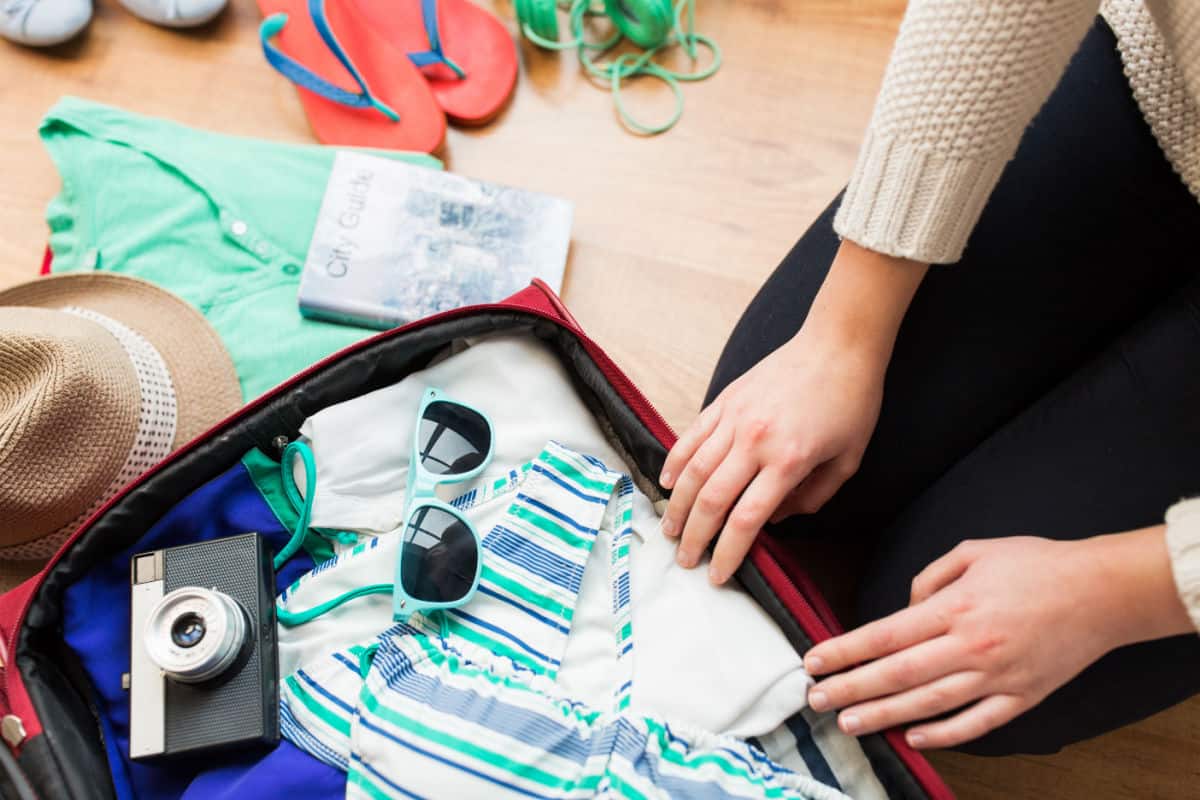 Woman packing suitcase.