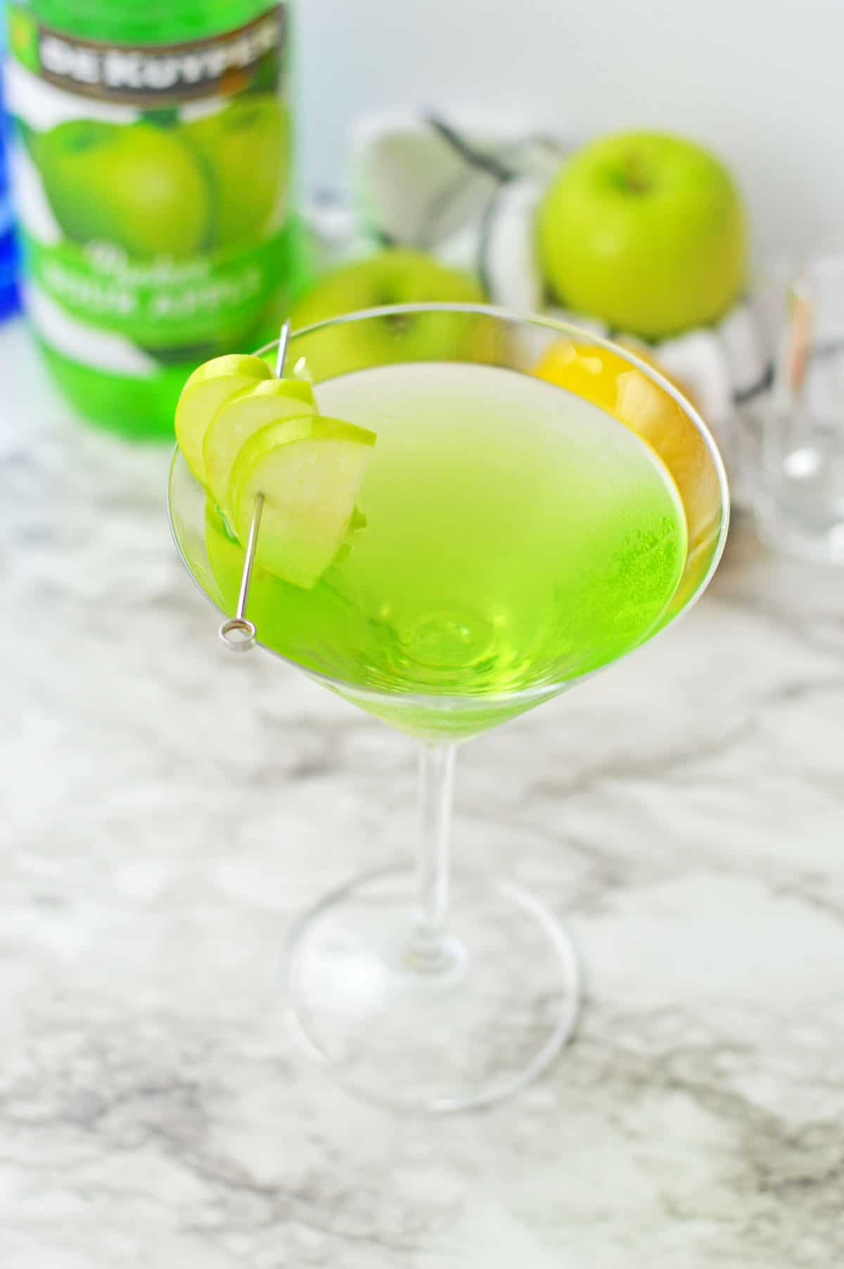 Green apple martini in a martini glass.
