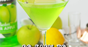 Green martini in martini glass with green apple slices.