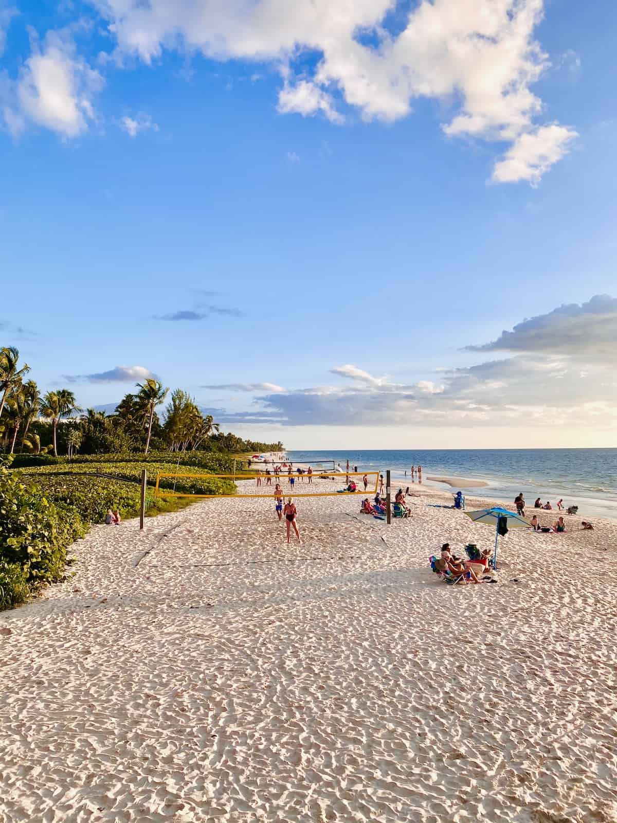 People playing volleyball on the beach.