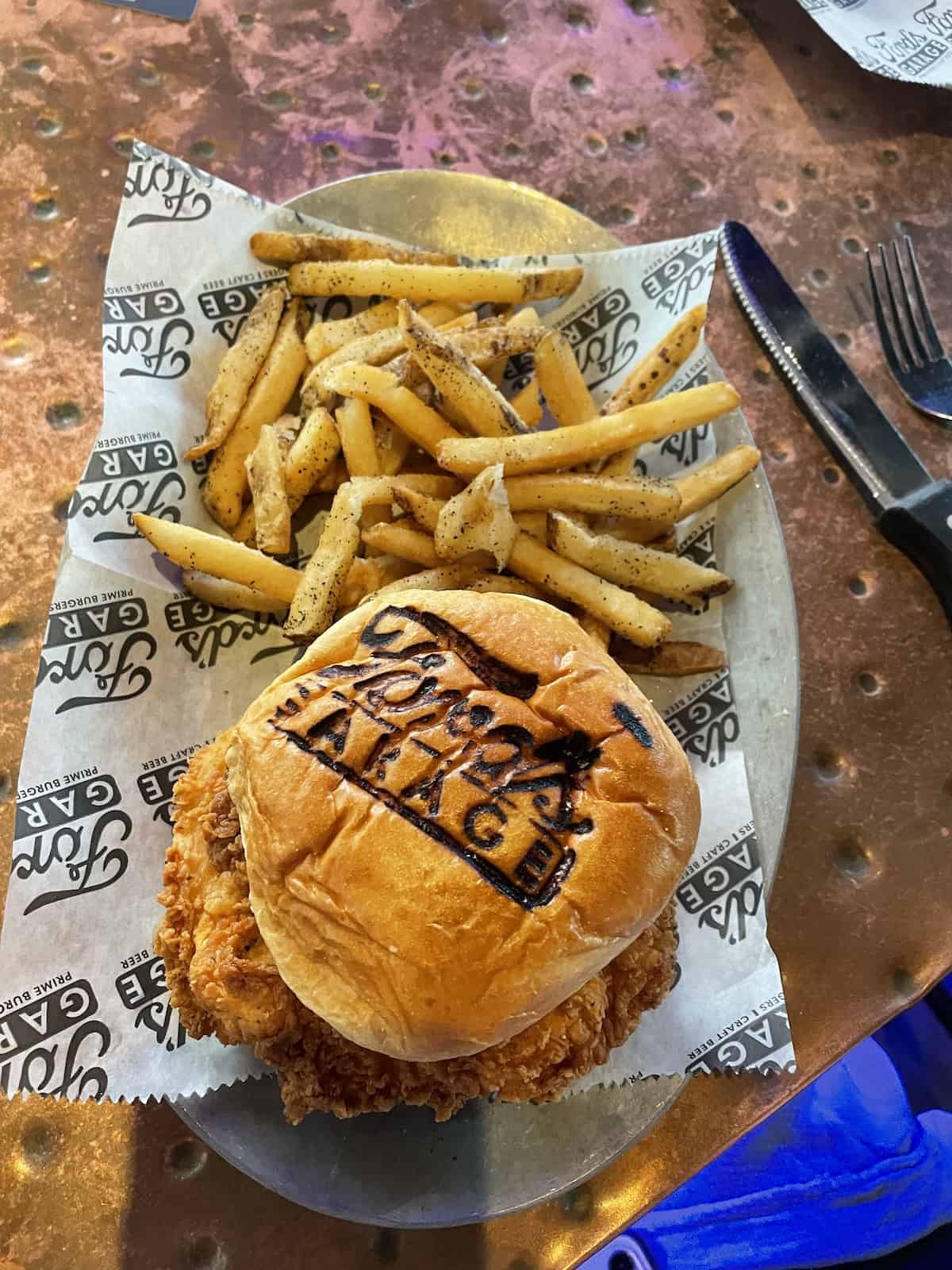 Fried chicken on a bun with Ford's Garage seared into it.